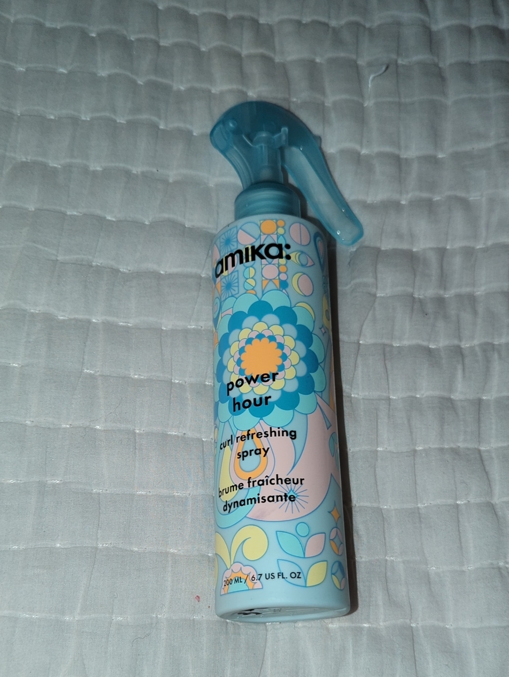 amika Power Hour Curl Refreshing Spray — blue and yellow bottle
